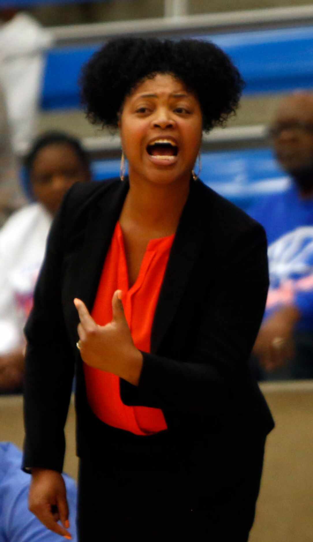 Arlington Bowie head coach Kelly Carruthers directs her players from the team bench area...
