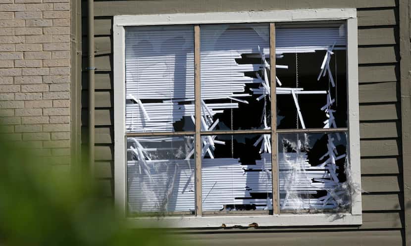  Blinds are shredded in windows broken by a hailstorm in Plano. (LM Otero/The Associated Press)