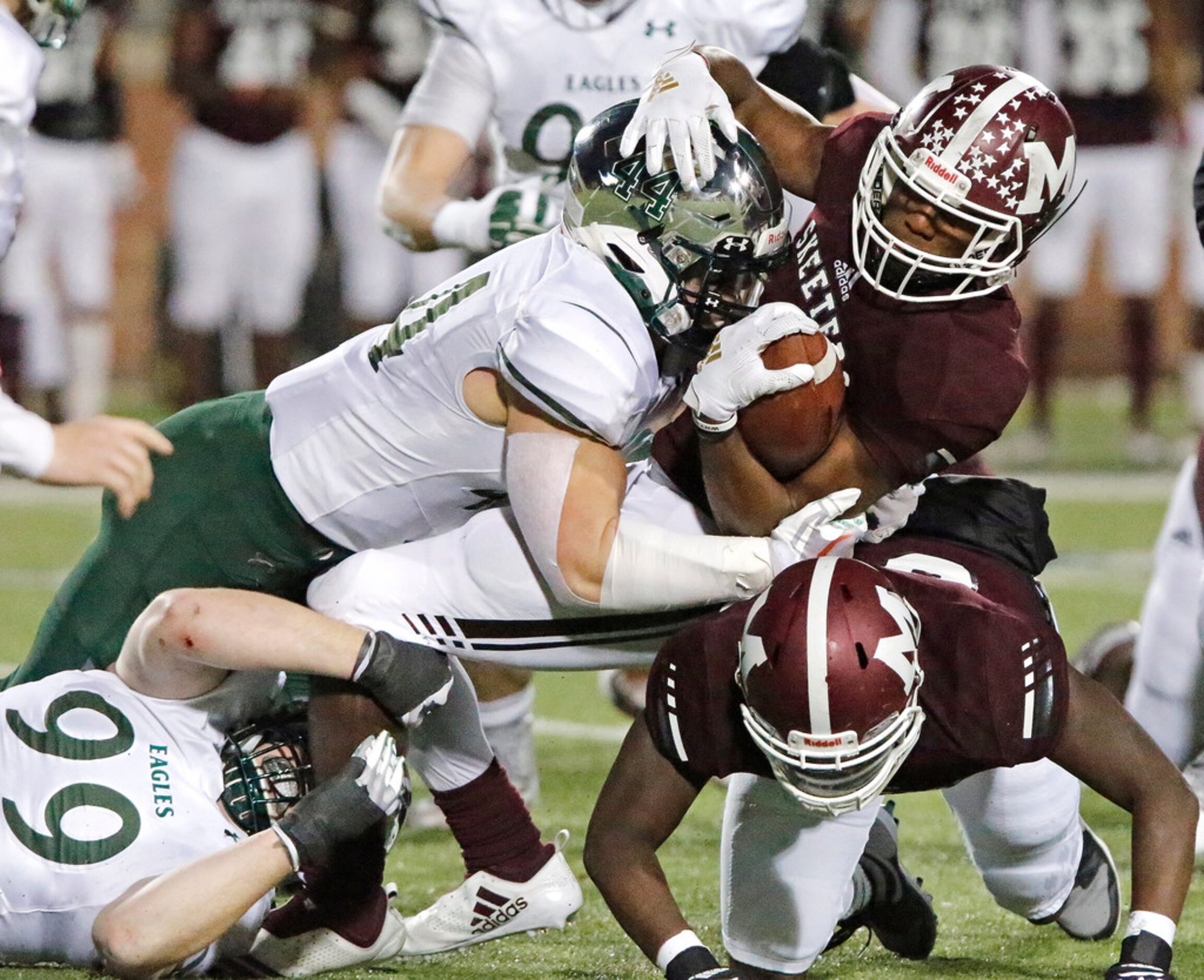 Mesquite High School running back Ladarius Turner (4) is tackled by Prosper High School...