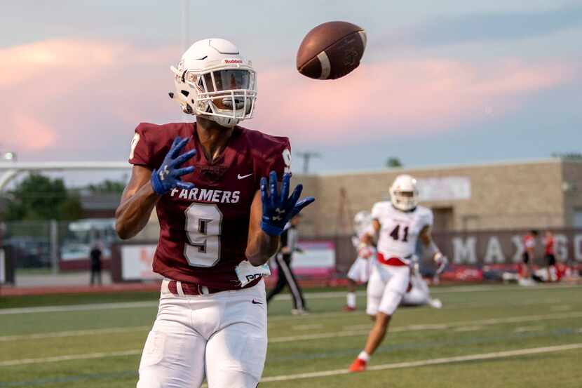 Lewisville sophomore wide receiver Armani Winfield (9) hauls in a touchdown pass after it...