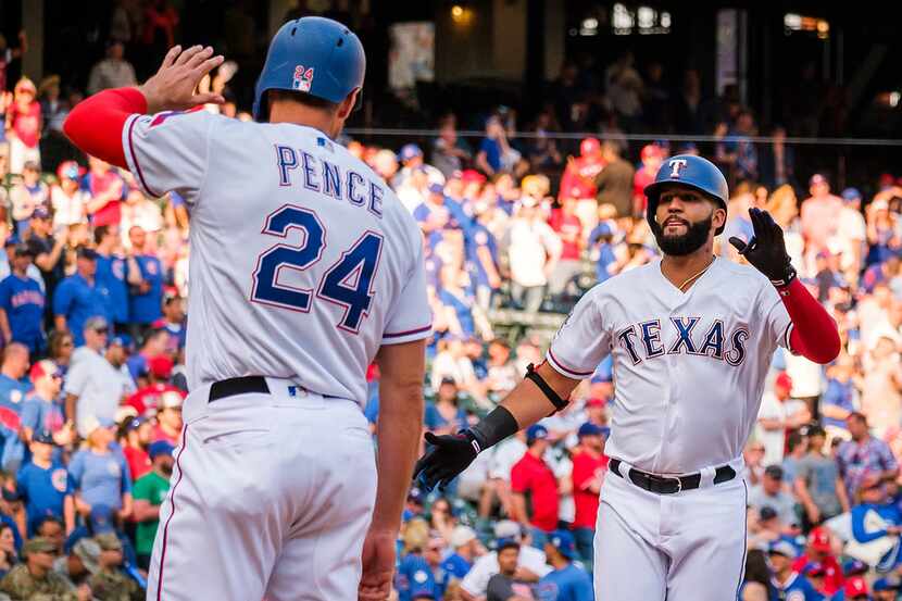Texas Rangers right fielder Nomar Mazara celebrates with designated hitter Hunter Pence...