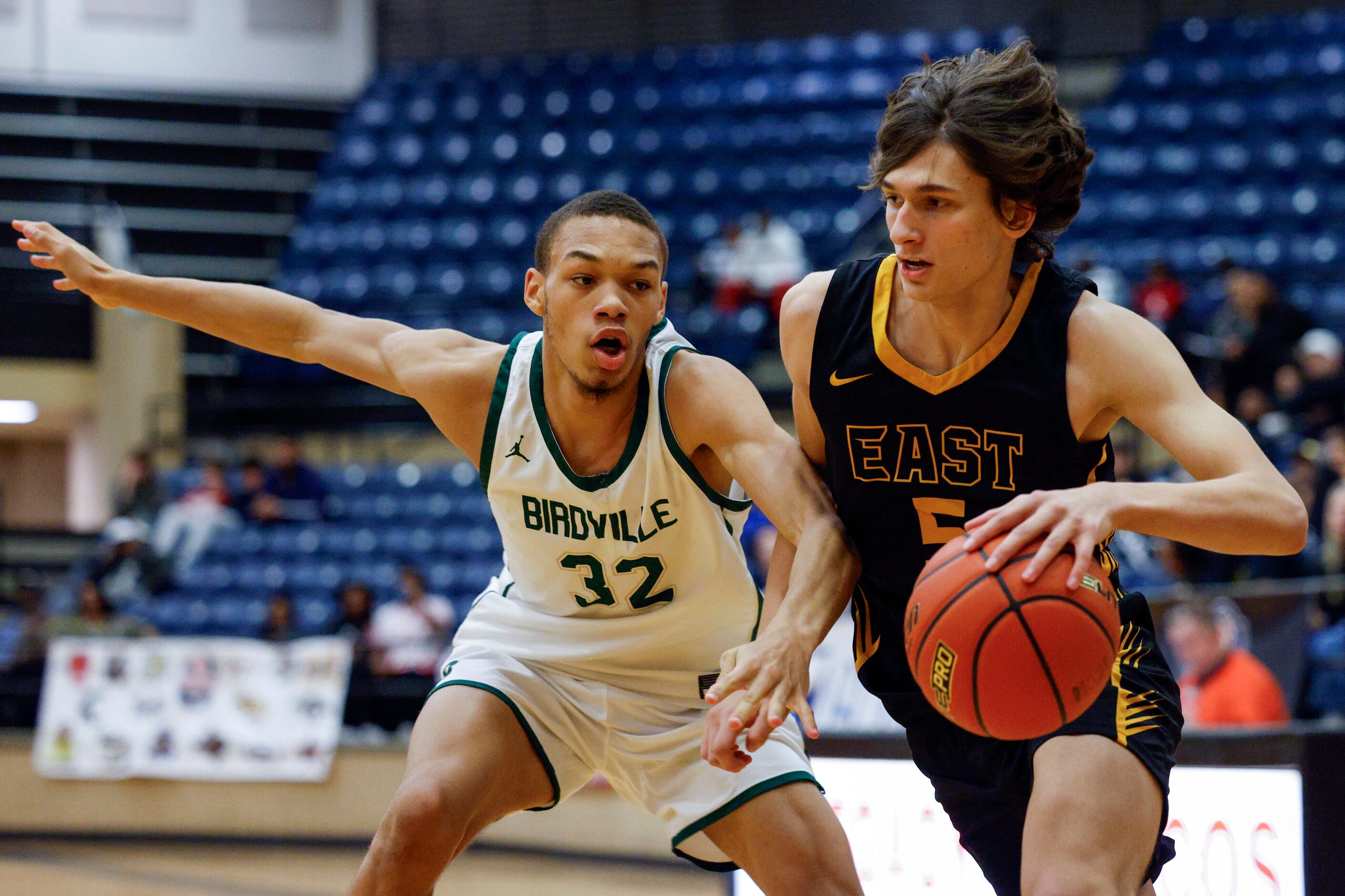 Plano East wing Ethan Moss (5) dribbles around Birdville guard Orlando Stuckey (32) during...