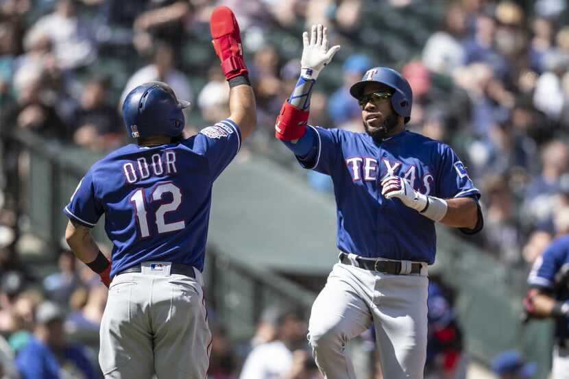 SEATTLE, WA - APRIL 28: Elvis Andrus #1 of the Texas Rangers is congratulated by Rougned...