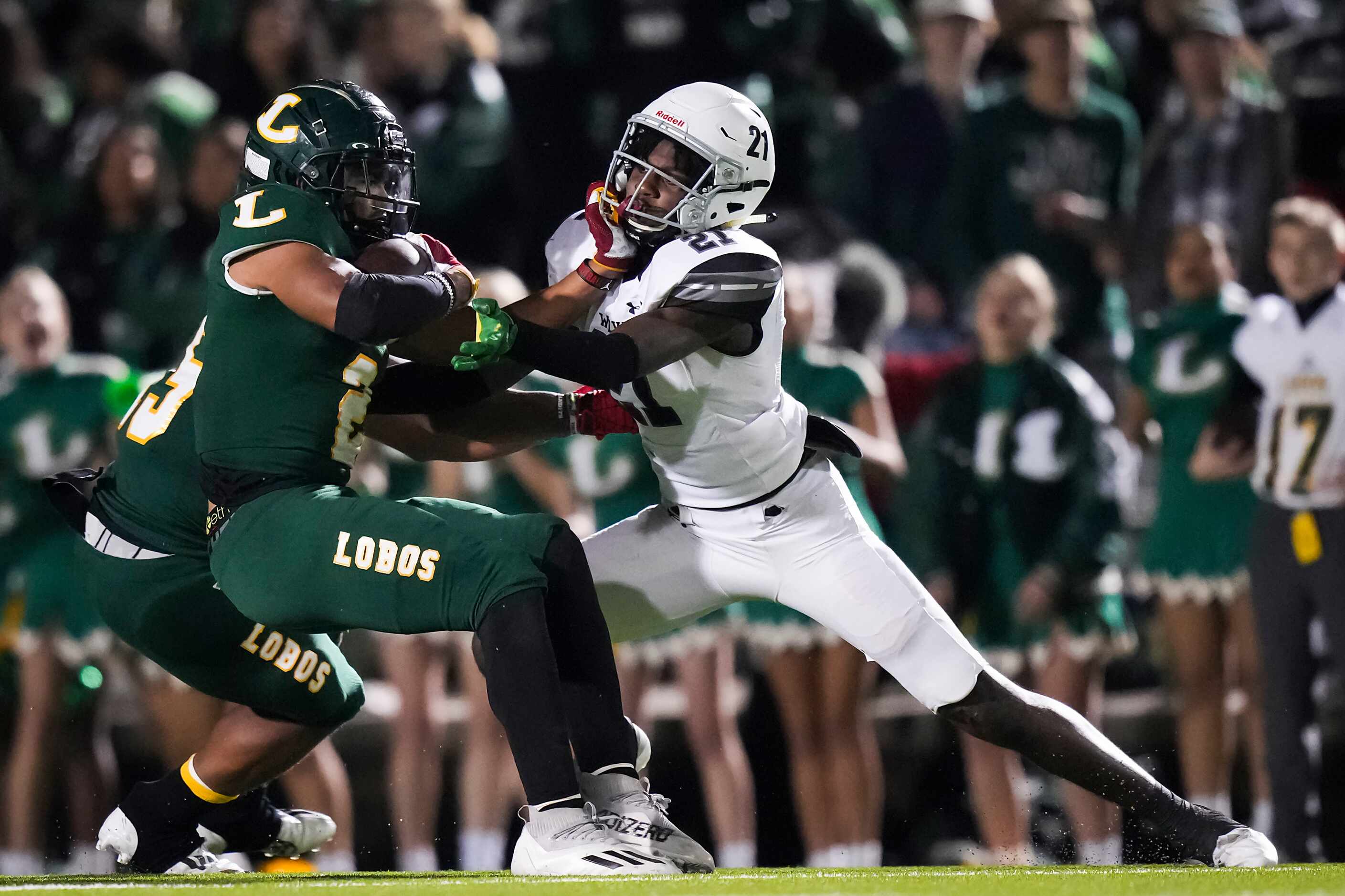 Longview running back  Taylor Tatum (2) is brought down by Mansfield Timberview defensive...