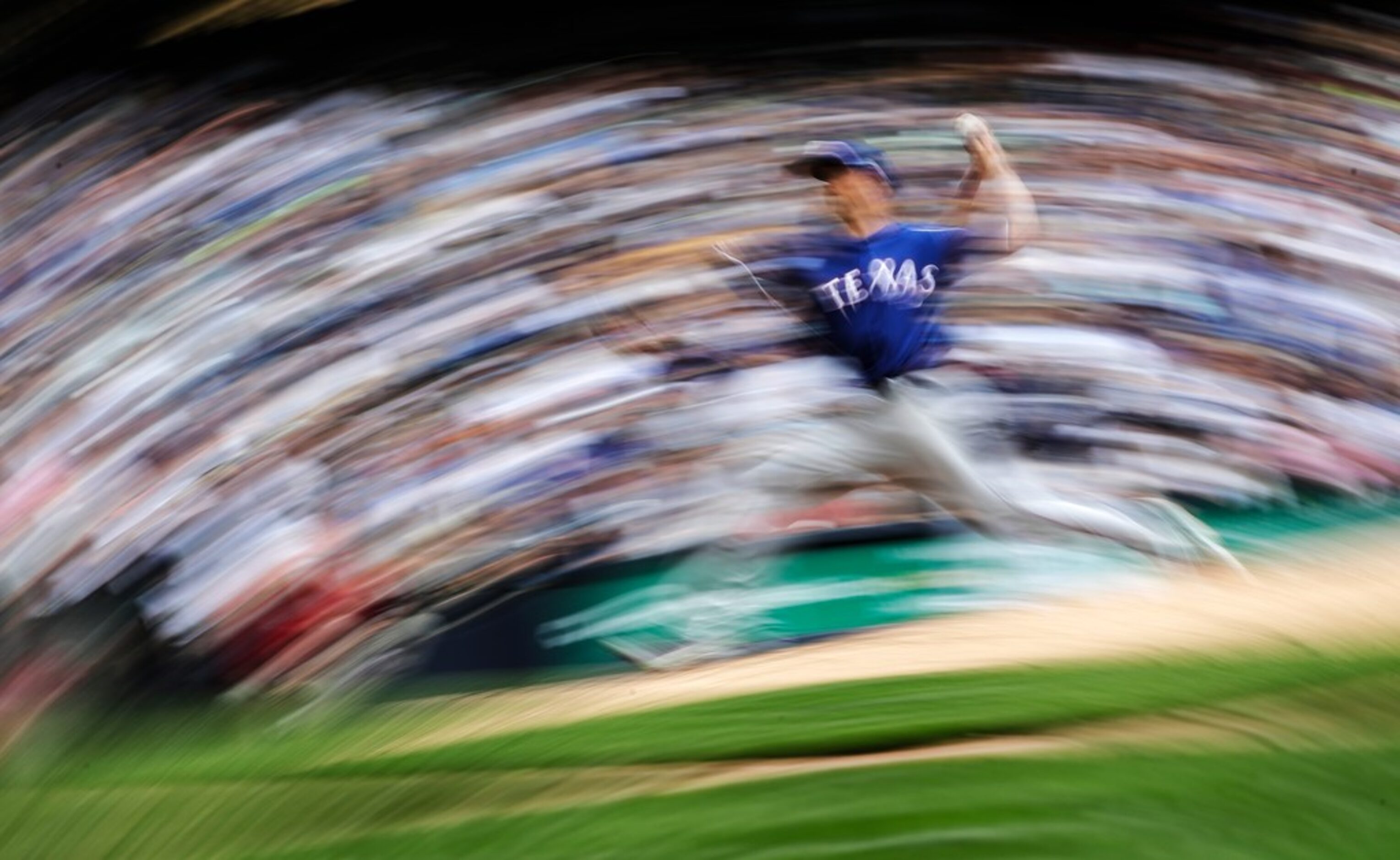 Texas Rangers starting pitcher Mike Minor throws during the seventh inning of a baseball...