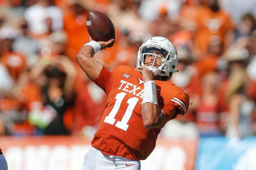 Texas quarterback Casey Thompson (11) throws a touchdown pass to wide receiver Joshua Moore...