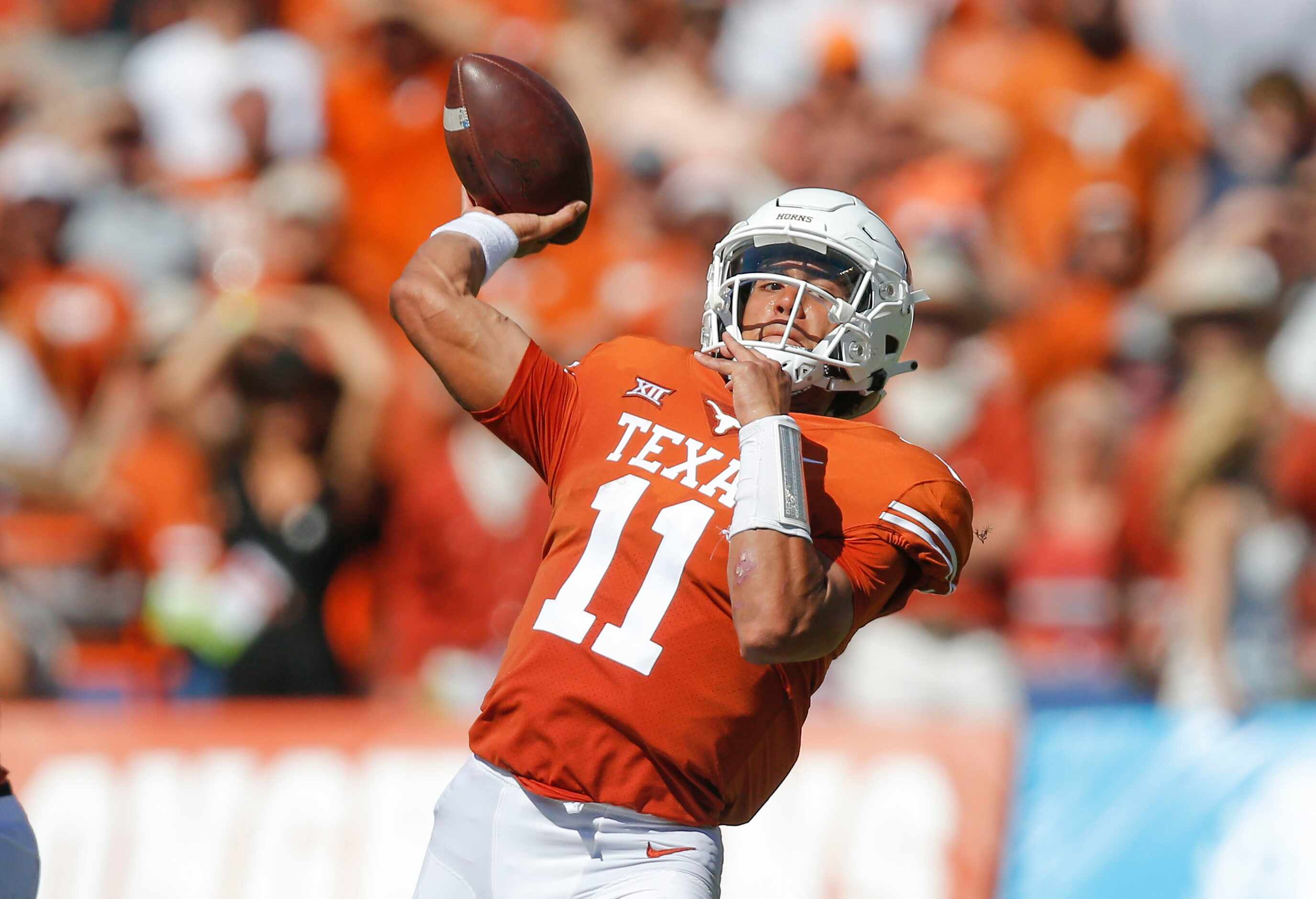 Texas quarterback Casey Thompson (11) throws a touchdown pass to wide receiver Joshua Moore...