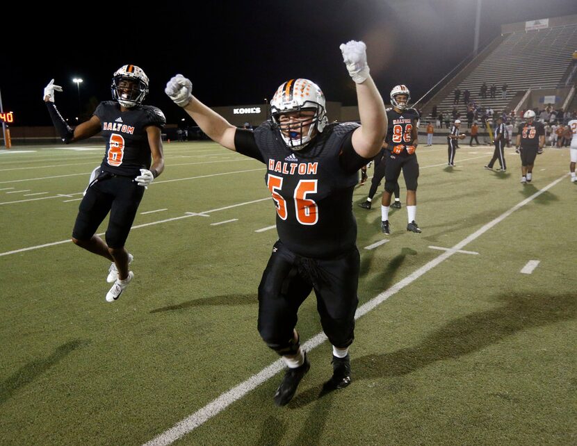 Haltom's Julian Johnson (8) and Mikel Estrello (56) celebrate their victory over Arlington...