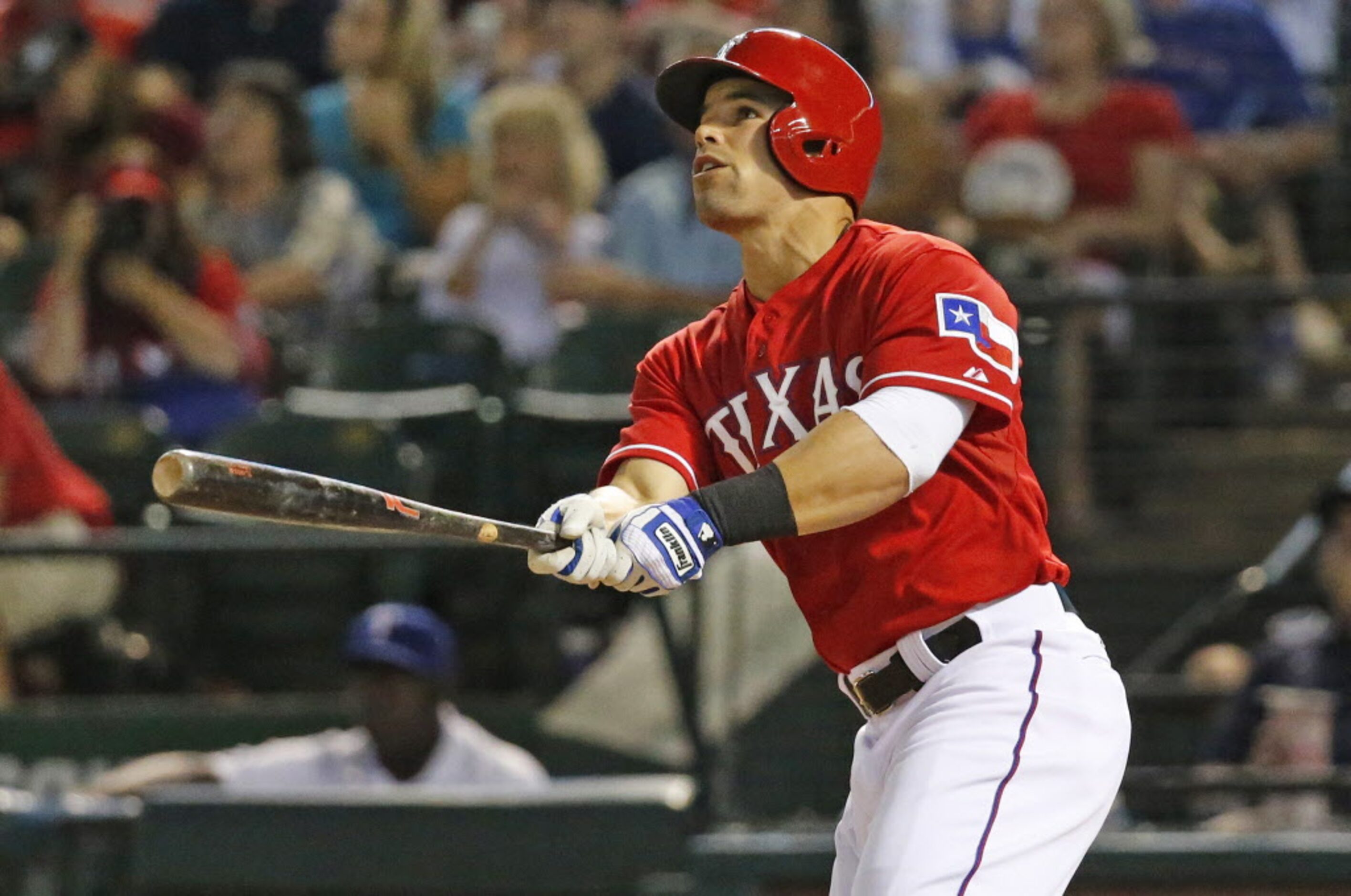 Texas' Jake Smolinski watches the flight of his fourth-inning solo homer during the Oakland...