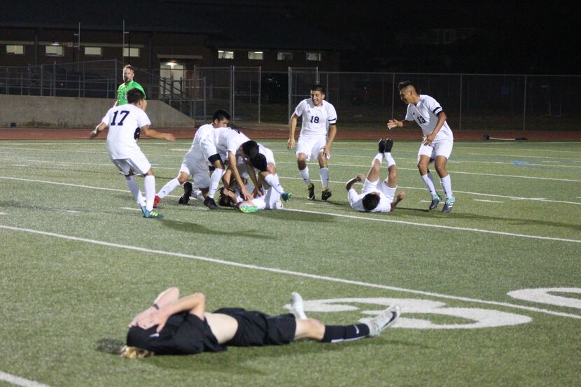 Life Oak Cliff players pile on No. 10 David Lopez to celebrate his game-winning goal against...
