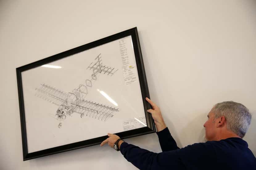 
Aviation instructor Jerry Ashton hangs a picture of a Van’s RV-12 aircraft during a class...