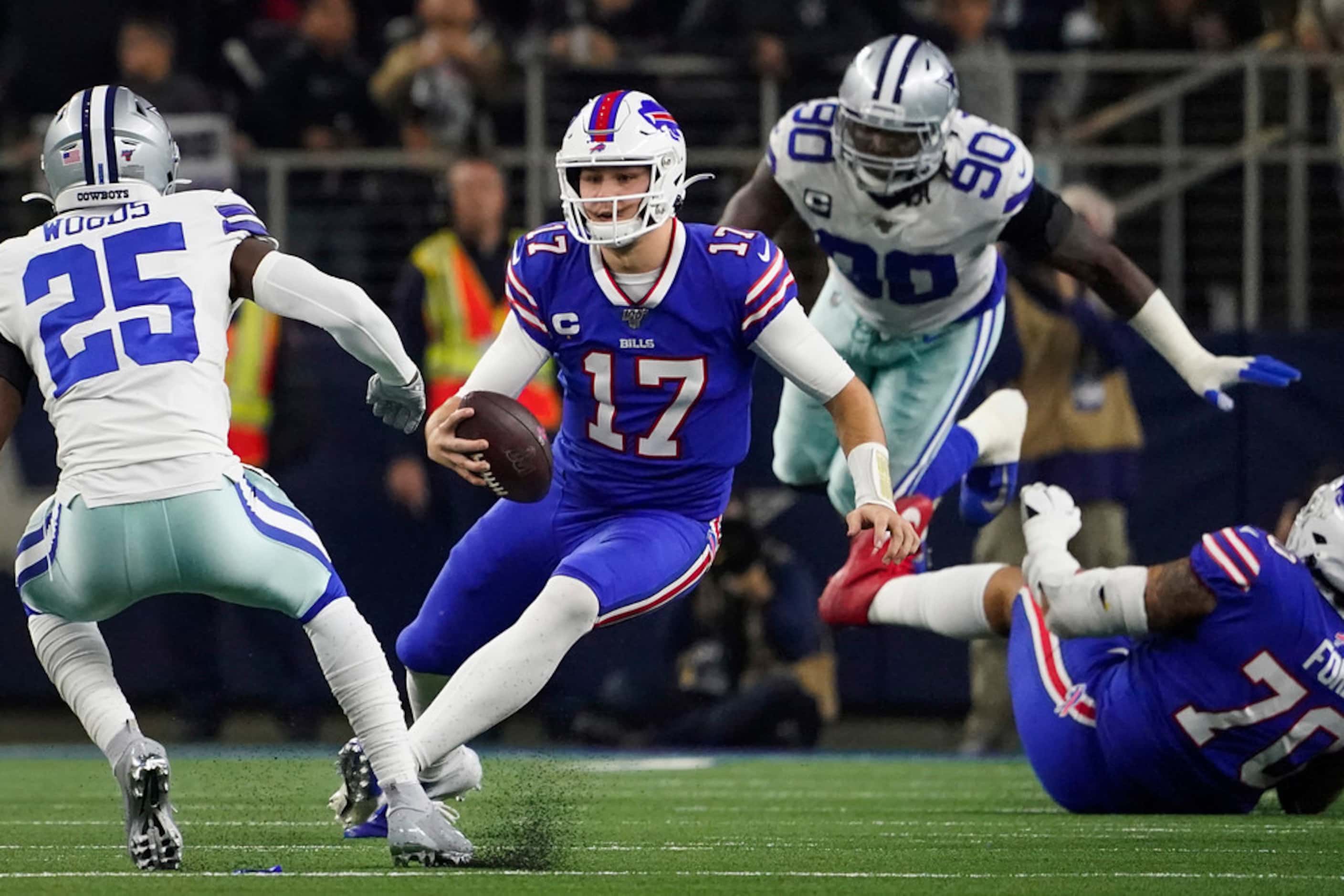 Buffalo Bills quarterback Josh Allen (17) scrambles for a first down between Dallas Cowboys...