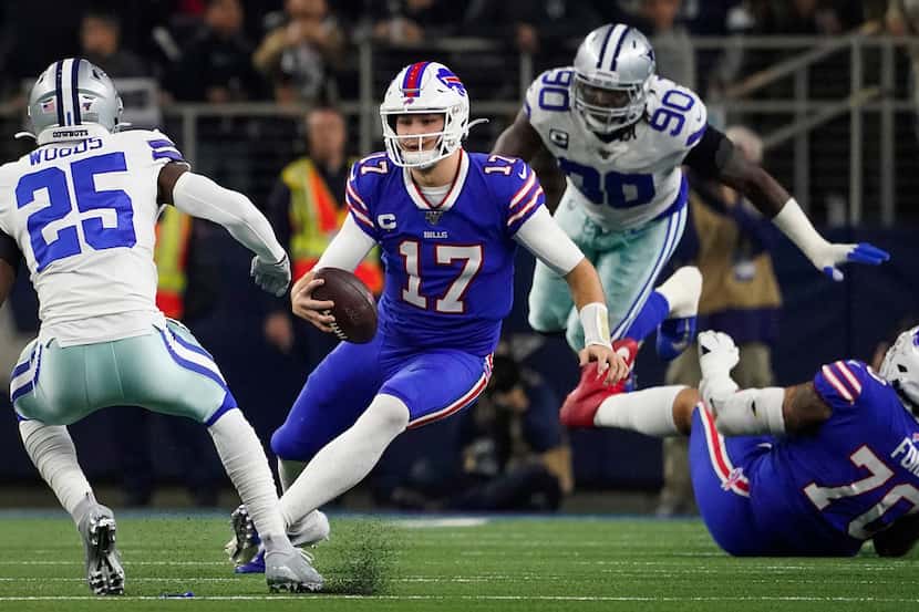 Buffalo Bills quarterback Josh Allen (17) scrambles for a first down between Dallas Cowboys...