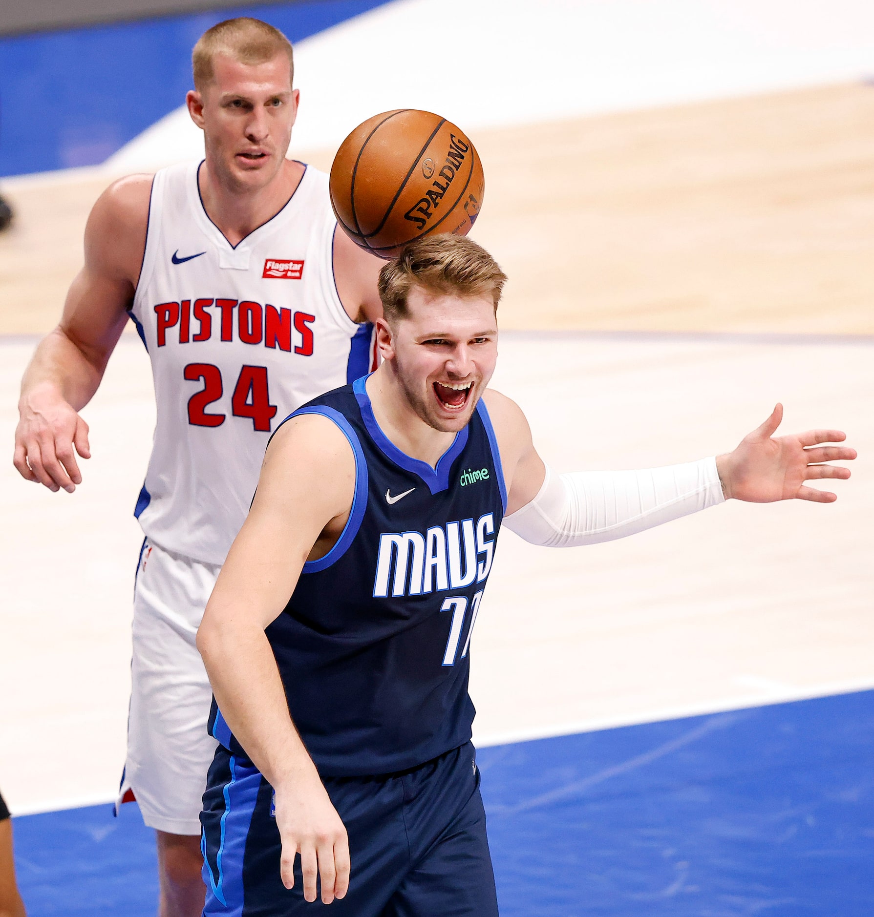 Dallas Mavericks guard Luka Doncic (77) reacts towards his teammates driving and dunking...