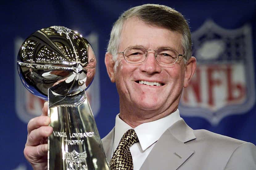 Atlanta Falcon's Coach Dan Reeves holds the Vince Lombardi Super Bowl trophy after...