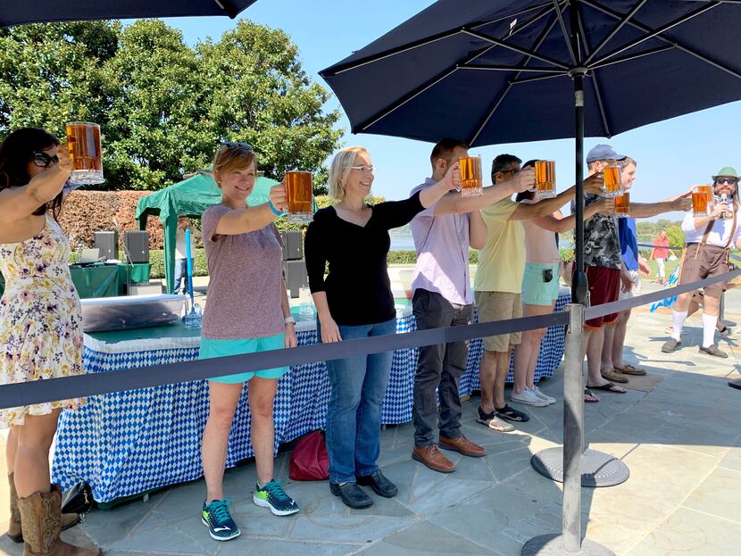 People participate in a stein-holding competition at the Dallas Arboretum's Oktoberfest...