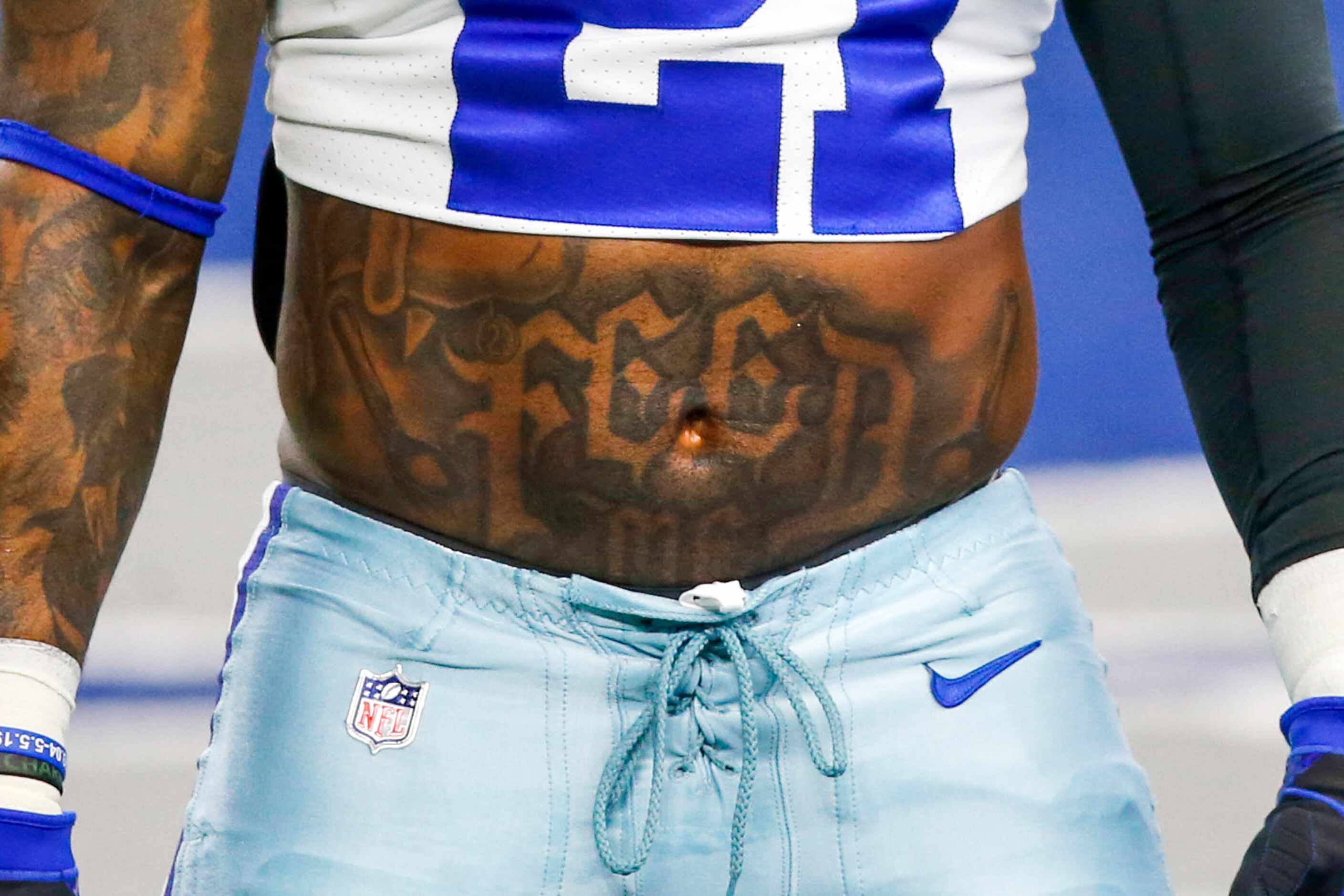 Dallas Cowboys running back Ezekiel Elliott (21) sports a "feed me," tattoo at a game...