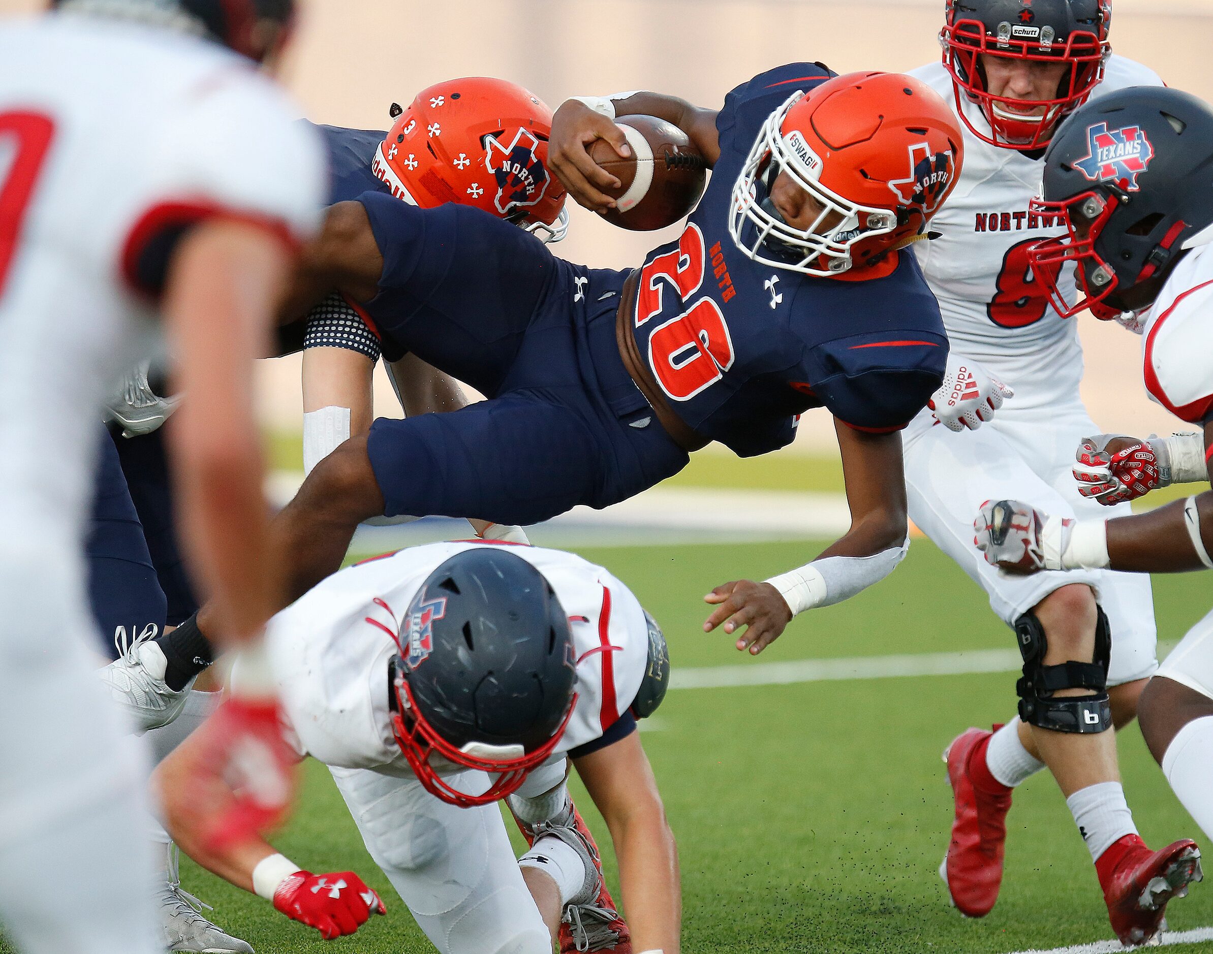 McKinney North High School running back Elijiah Alexander (20) goes sideways during the...