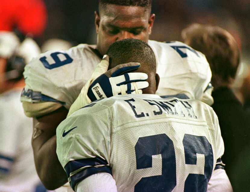 11-24-96---Dallas Cowboys tackle Erik Williams talks  with running back Emmitt Smith in the...