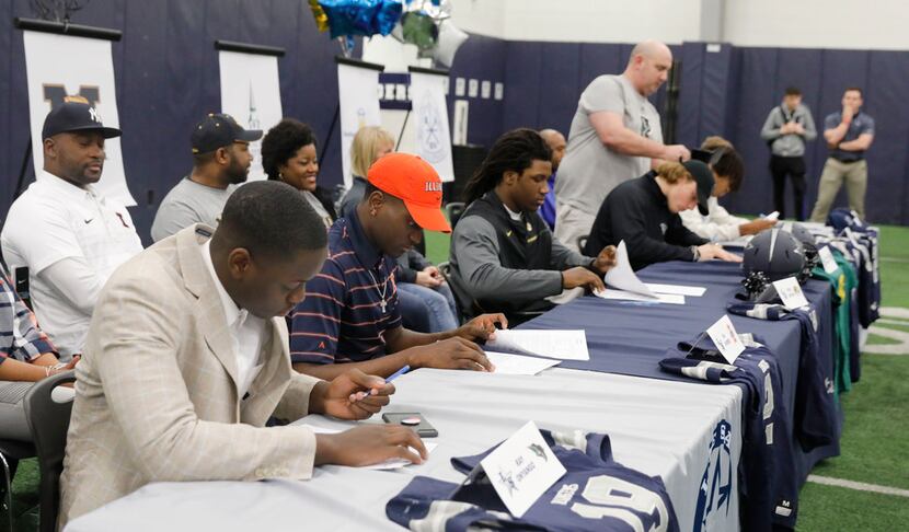 Frisco Lone Star High School football players sign their letters of intent, as family...