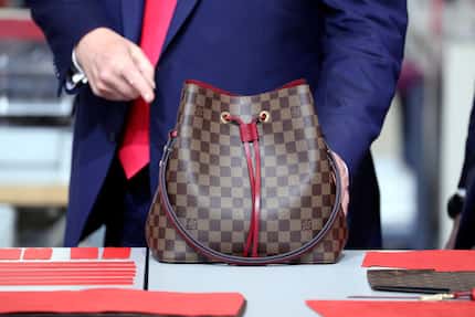 President Donald Trump looks at a bag during his visit to the new Louis Vuitton workshop.