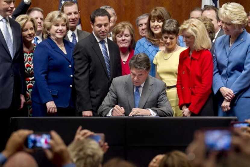 Texas Gov. Rick Perry signs restrictive abortion bill