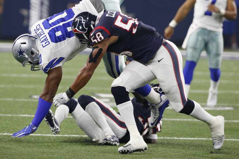 Dallas Cowboys tight end Rico Gathers (80) flips over Houston Texans outside linebacker...