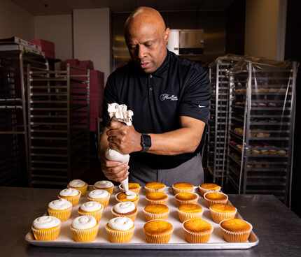 Owner Keith Fluellen frosts cupcakes at Fluellen Cupcakes in Dallas. Fluellen Cupcakes, a...