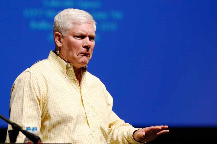 Rep. Pete Sessions, R-Dallas, reacts after the crowd erupted during the question portion of...