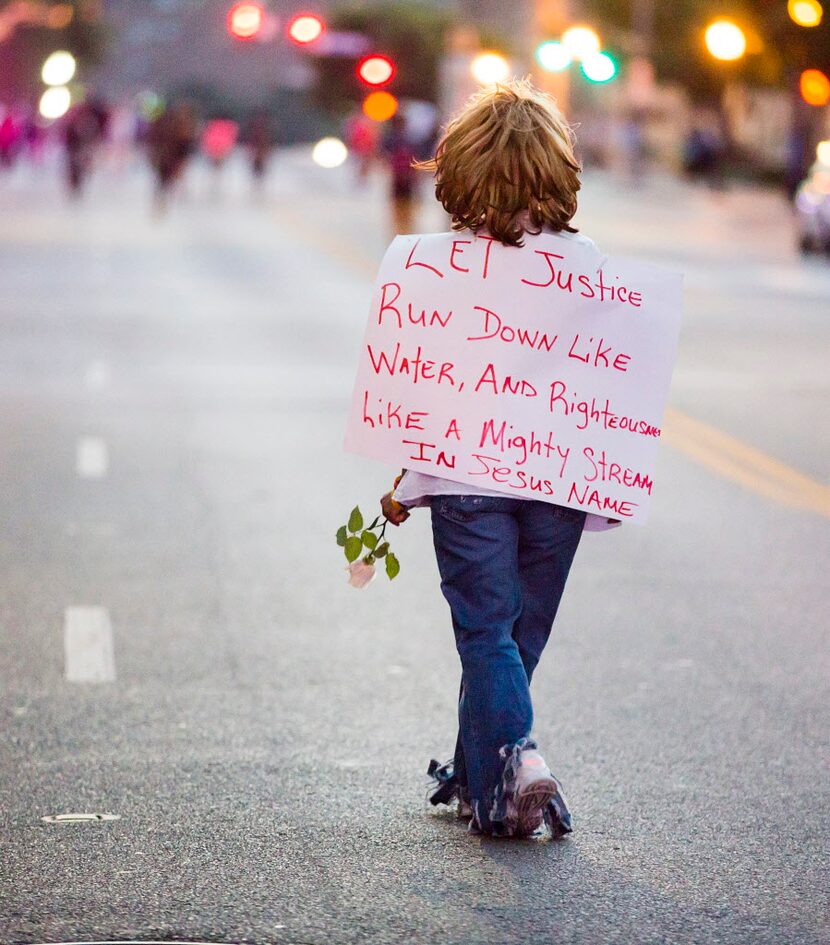 One the final marchers walks through Main at Lamar during a Black Live Matter rally in...