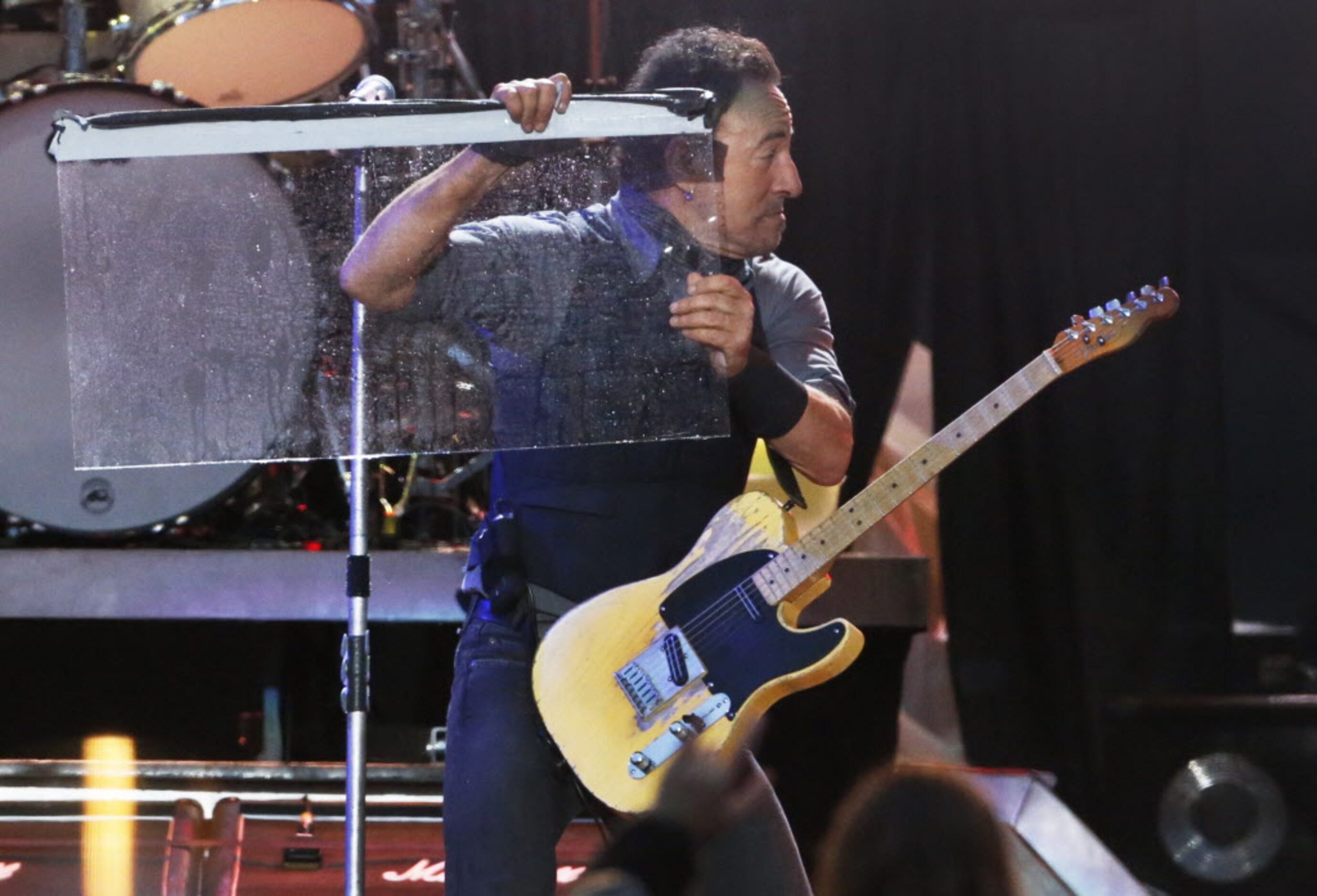 Bruce Springsteen pulls up a piece of the stage and discards it as he performs during the...