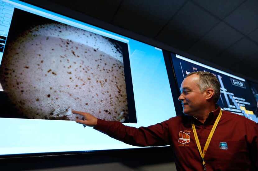 NASA engineer and InSight project manager Tom Hoffman points to the first image upon a...