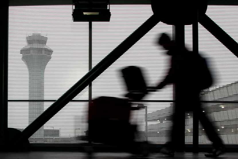 In this Dec. 21, 2013 file photo, a traveler walks through Terminal 3 at O'Hare...