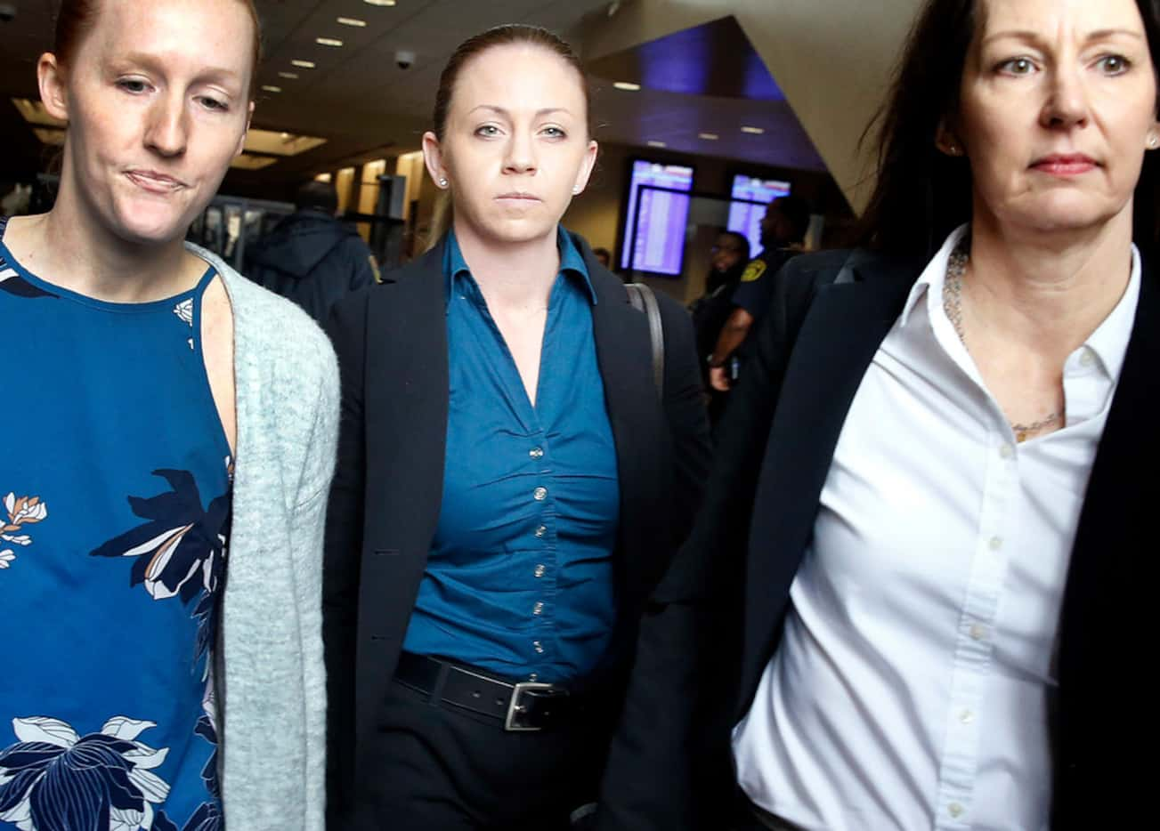 Former Dallas police Officer Amber Guyger (center) leaves the Frank Crowley Courts Building...