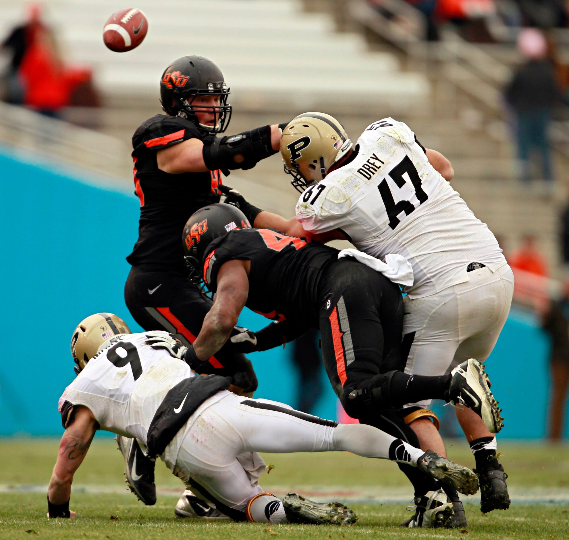 Purdue Boilermakers quarterback Robert Marve (9) fumbles the ball as he is sacked by...