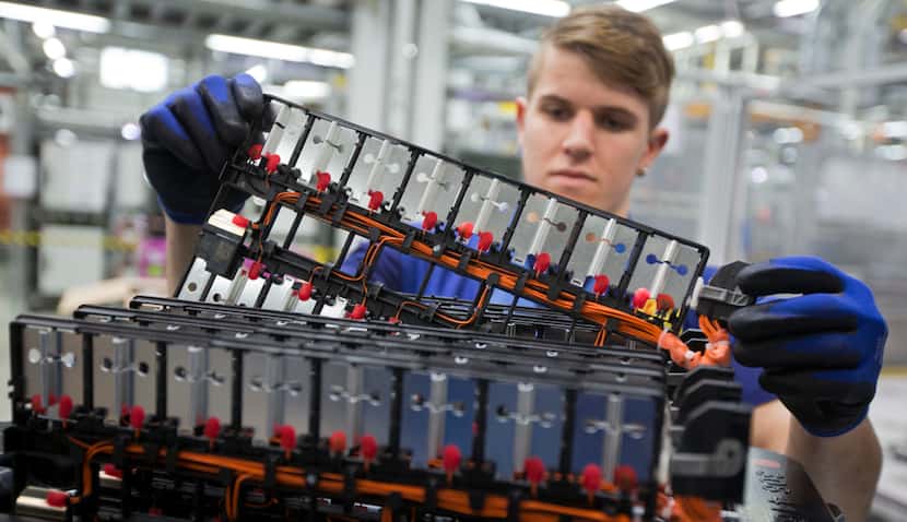 BMW employee Florian Bornschlegel works at the production line for electric drive modules...