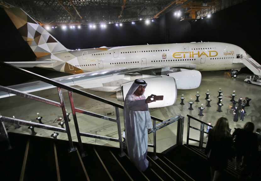 An Emirati man takes a selfie in front of a new Etihad Airways A380 in Abu Dhabi, United...
