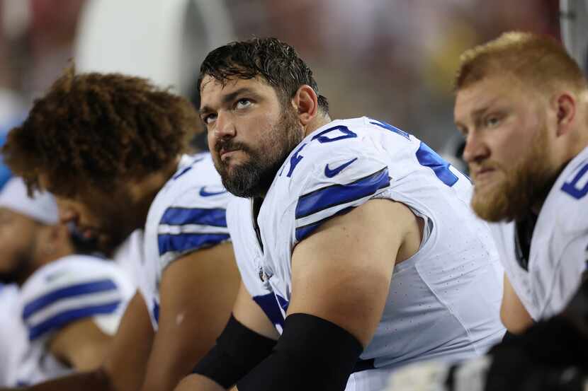 Dallas Cowboys guard Zack Martin sits on the bench during the second half of an NFL football...