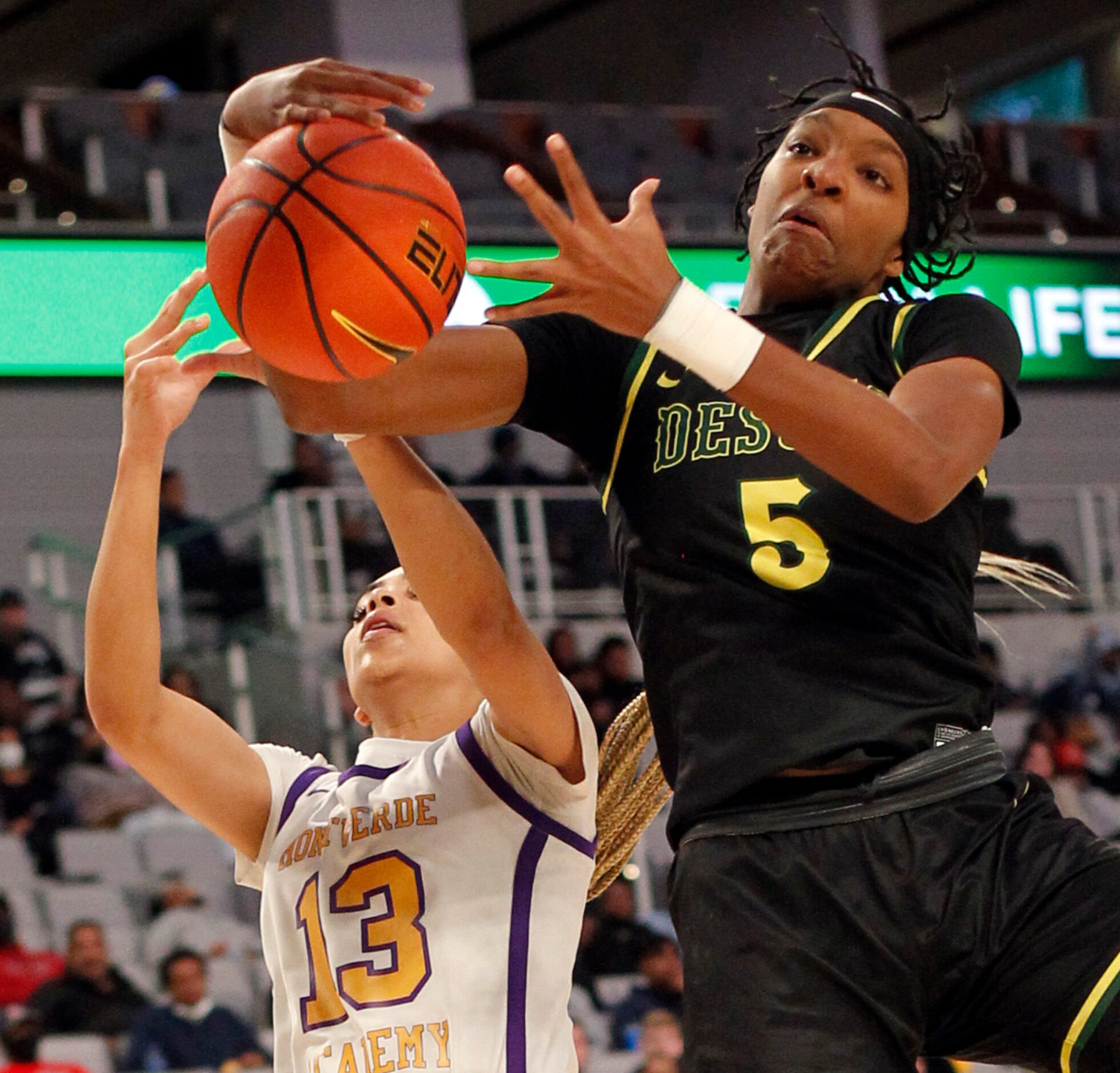 DeSoto senior Sa'Myah Smith (5) battles Montverde Academy guard Jordana Codio (13) for a...