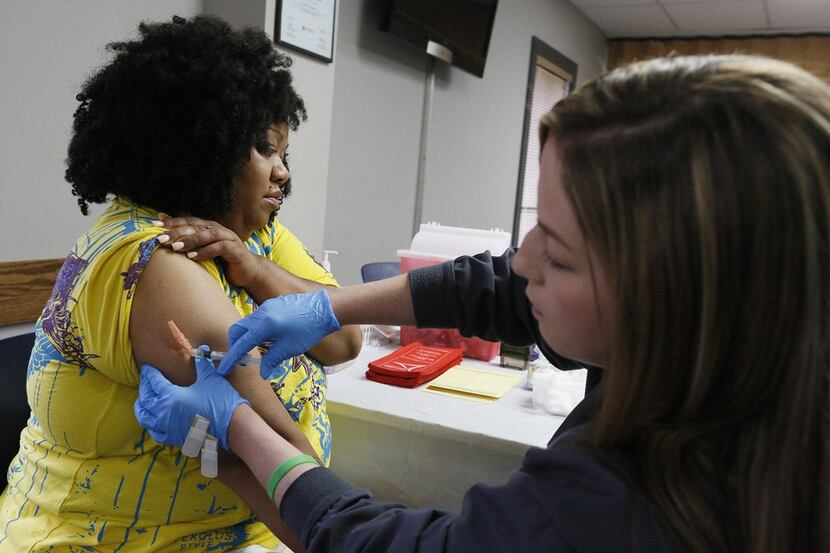 Nicole Stout, a Franklin County Public health nurse, gives  a measles shot to Nicole...