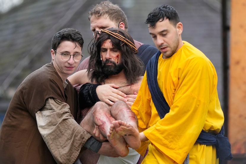 An actor portraying the part of Jesus Christ, is carried away after crucifixion during the...