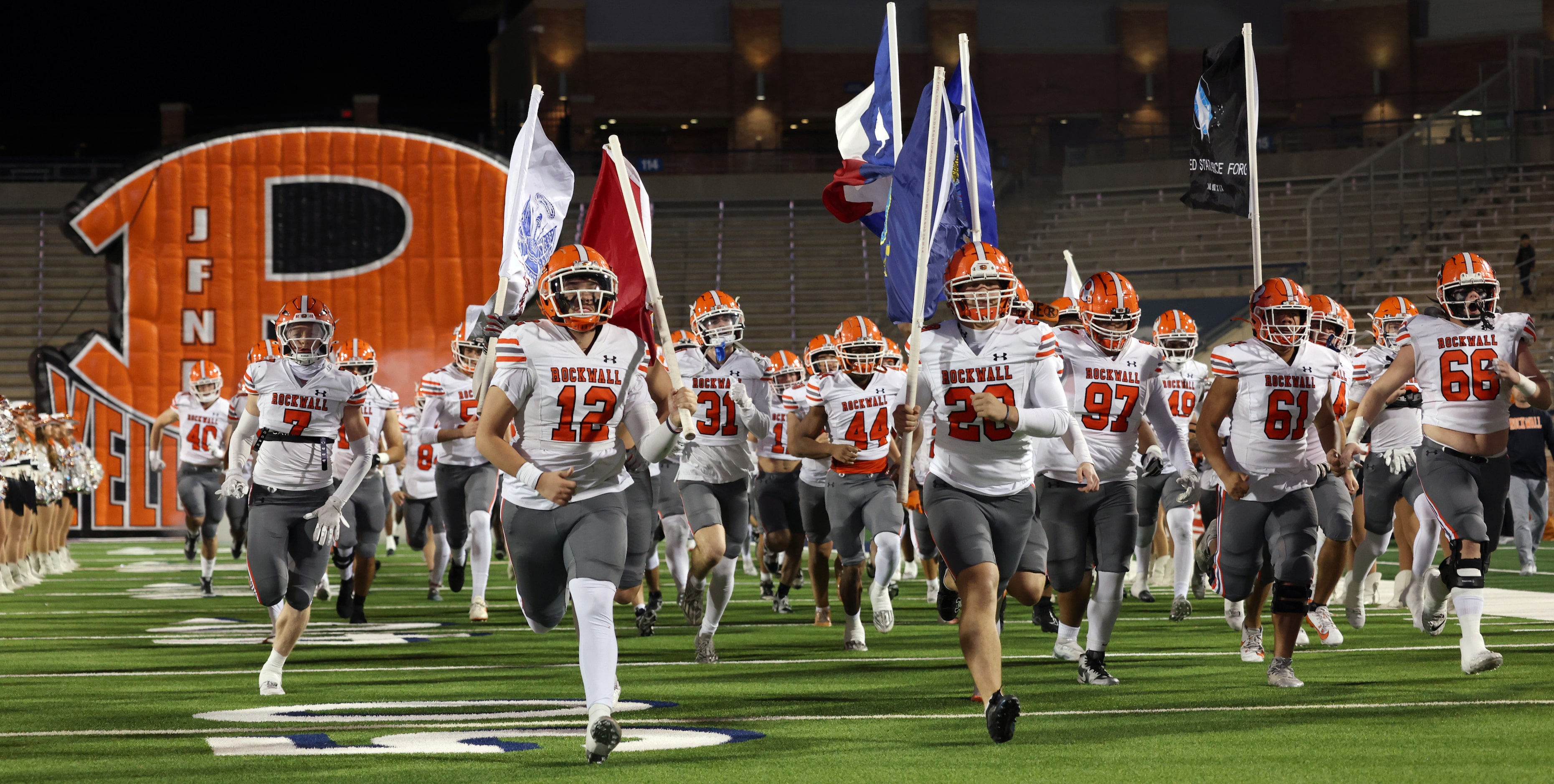 Rockwall players race onto the field from the team inflatable prior to the opening kickoff...