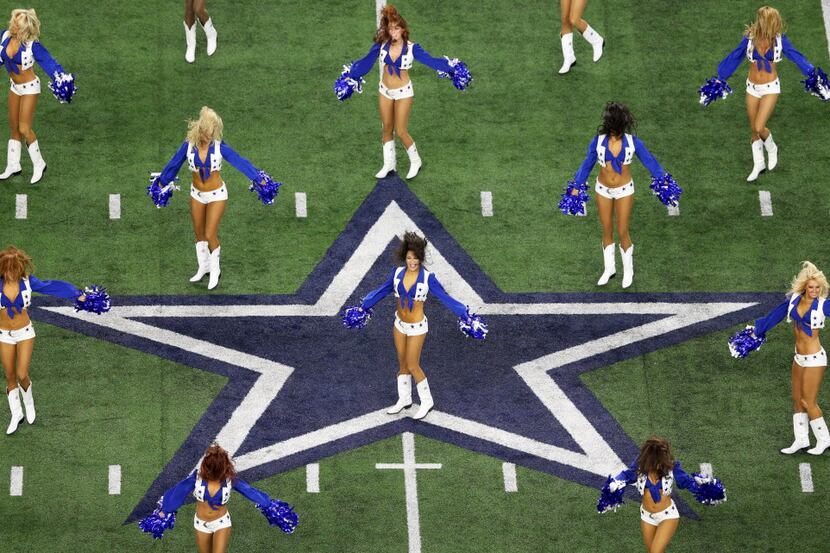 Dallas Cowboys cheerleaders perform before the team introductions in a game between the...