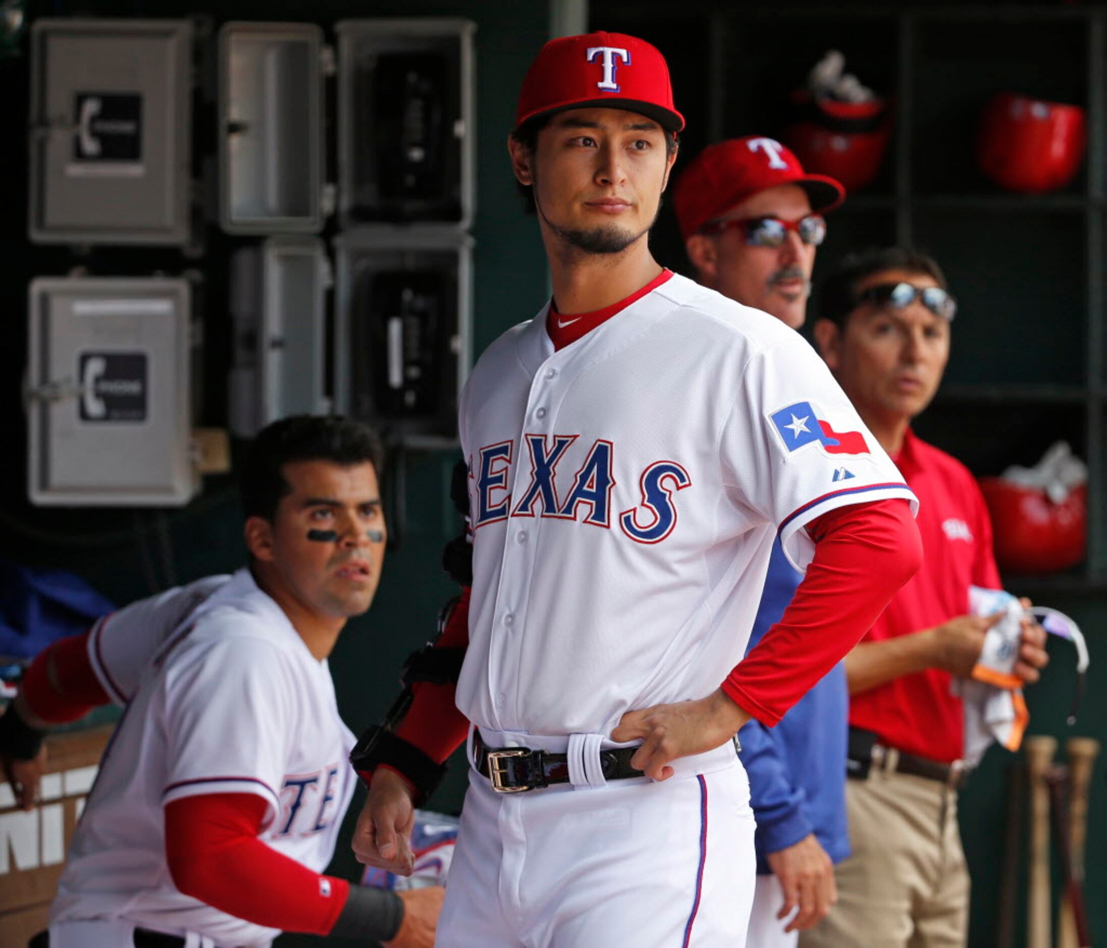 A newly-joined Texas Rangers Yu Darvish (L) shakes hands with his Iranian  father, Farsad Darvishsefad at Rangers Ballpark in Arlington, Texas, on  Jan. 21, 2012. The right-hand Japanese ace Darvish agreed to