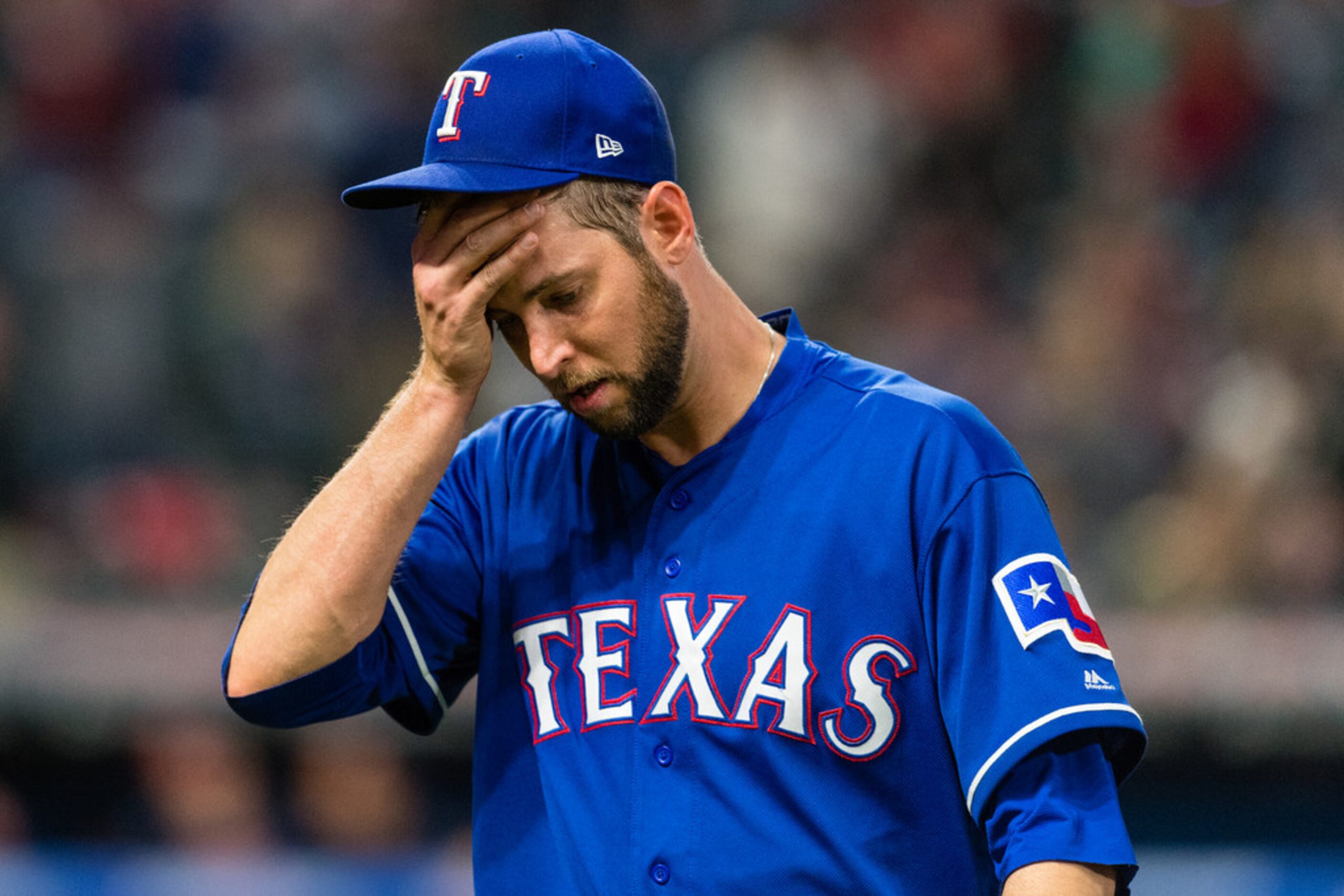 CLEVELAND, OH - APRIL 30: Pitcher Chris Martin #31 of the Texas Rangers reacts as he leaves...