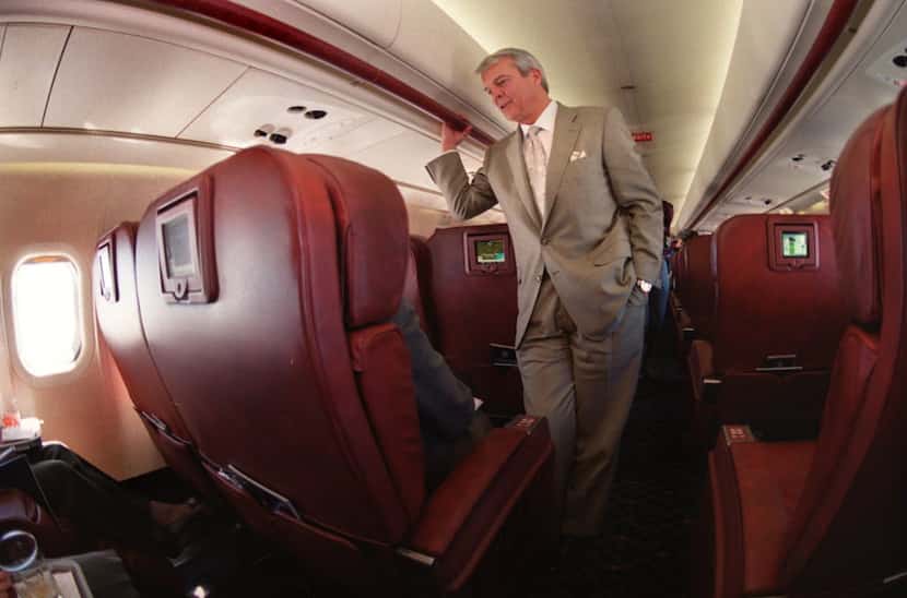 Legend Airlines President and CEO Allan McArtor visiting with a passenger on a flight to...