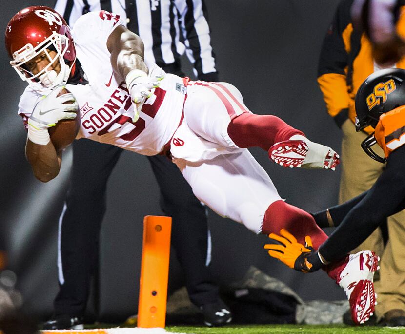 Oklahoma running back Samaje Perine (32) leaps into the end zone to score on 25-yard...