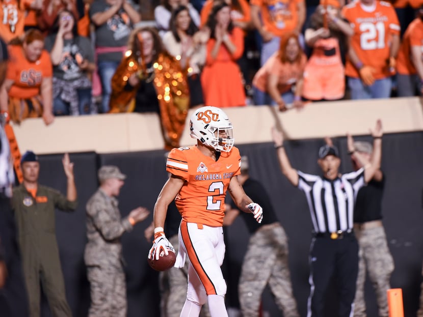 FILE - Oklahoma State wide receiver Tylan Wallace (2) walks after scoring a touchdown in the...