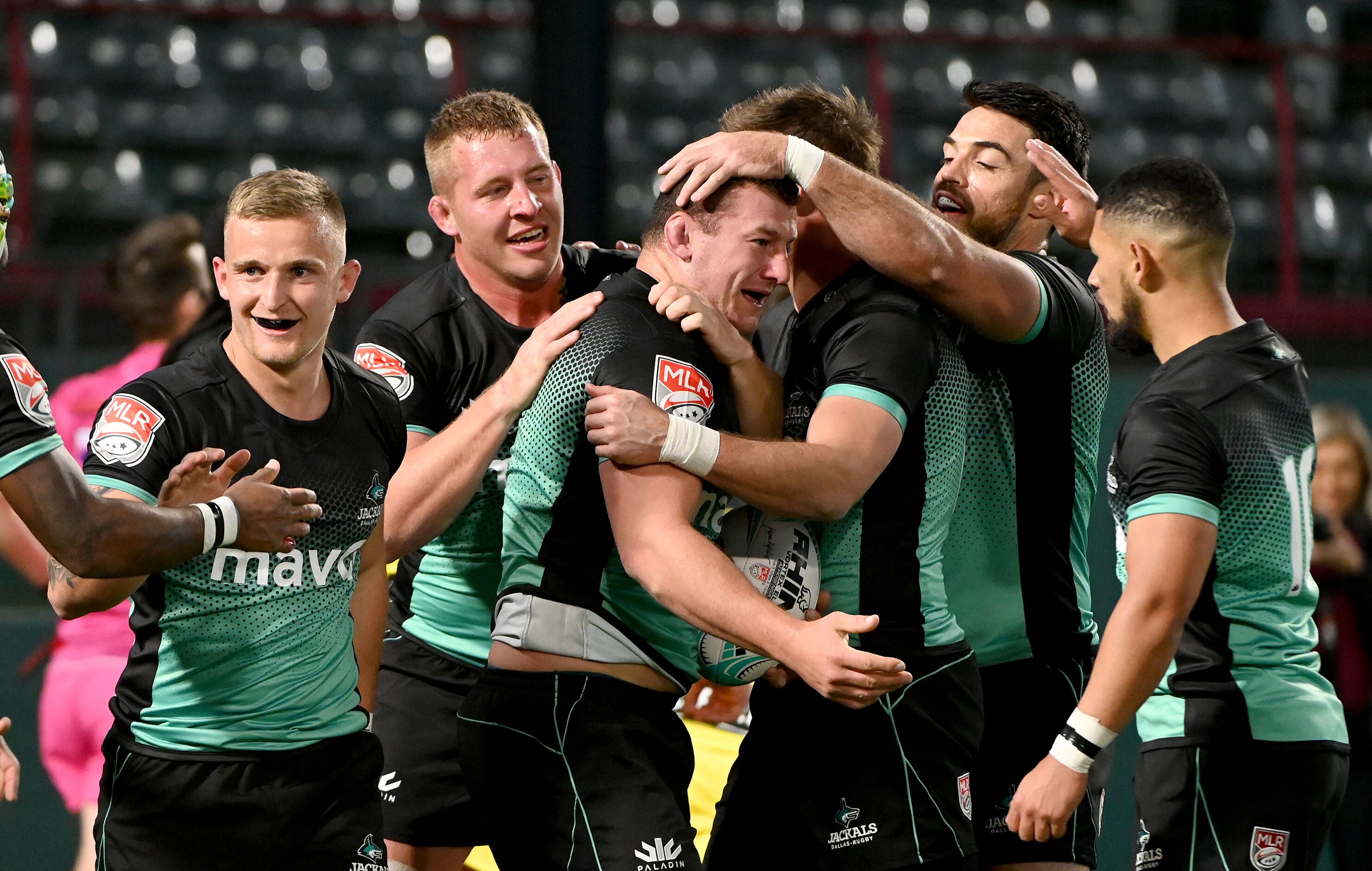 Dallas’ Matthew Frings, center with ball, celebrates teammate after a successful try during...