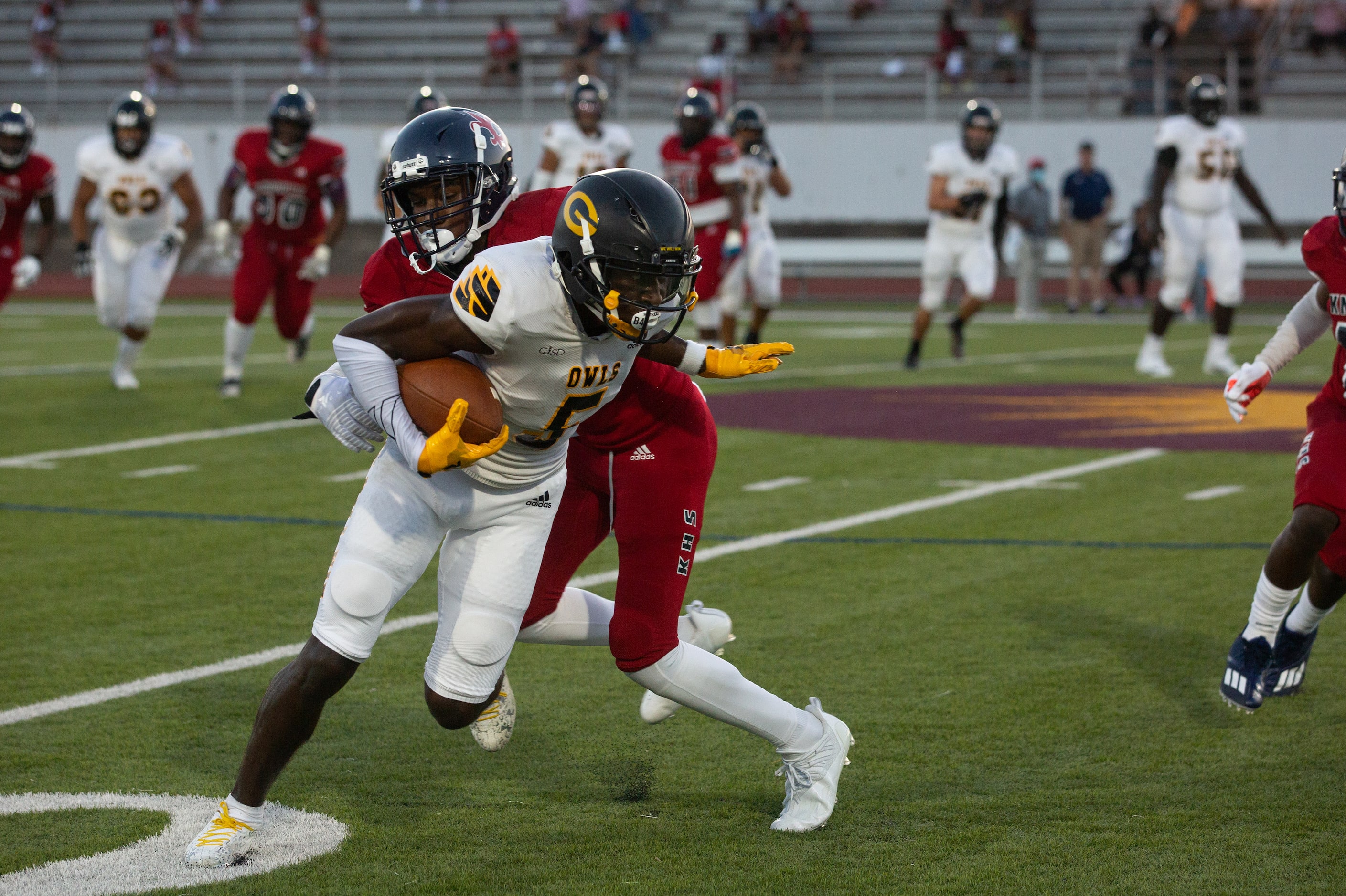 Garland High School wide receiver Jordan Hudson (5) powers through the defense during their...